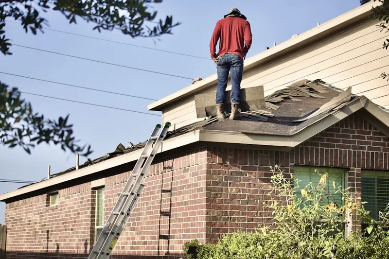 Professional roofer working on a residential roof in Cardinal View